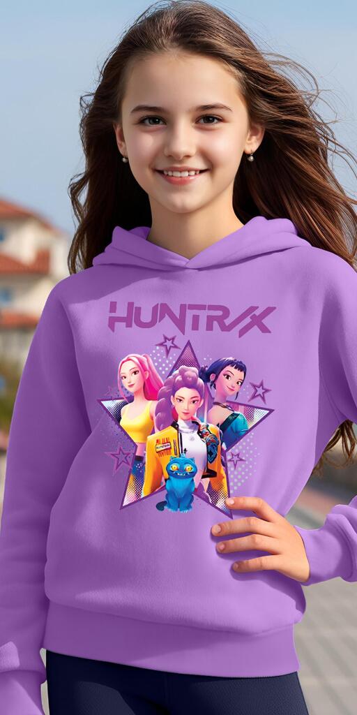 Дете позира с лилав суичър, на който е изобразен K-POP принт на три момичета и надпис "HUNTRX".